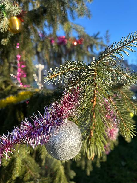 istock Christmas tree branches decorated with colorful balls and garlands 2254323795