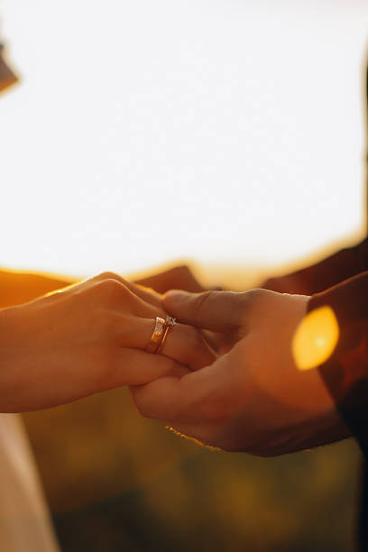 istock Couple exchanging wedding rings during a sunset ceremony 2254324864