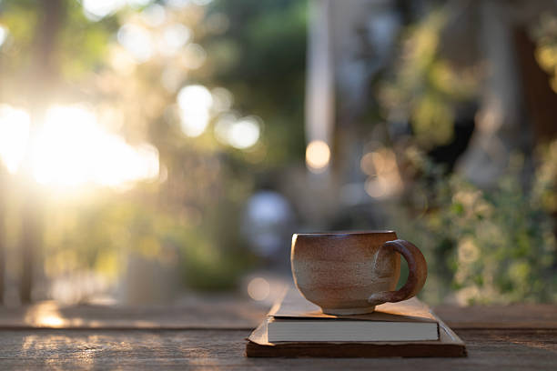Earthenware vintage brown clay coffee cup and notebook