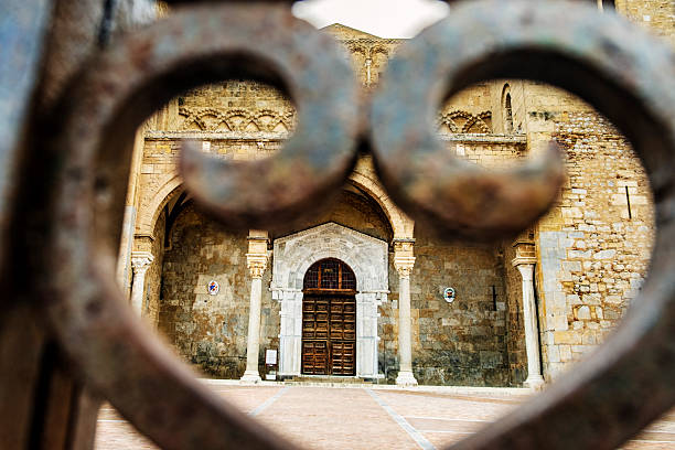 Cefalu Roman Catholic Cathedral in Sicily, photographed through the gate in front of it. The Cathedral dates back to the 12th Century and reflects Sicily’s rich history, featuring many different architectural styles.