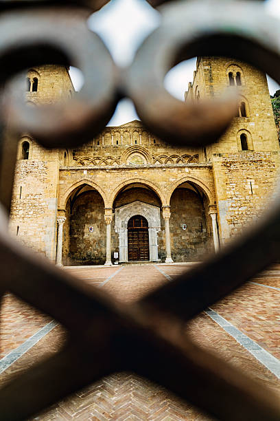 Cefalu Roman Catholic Cathedral in Sicily, photographed through the gate in front of it. The Cathedral dates back to the 12th Century and reflects Sicily’s rich history, featuring many different architectural styles.