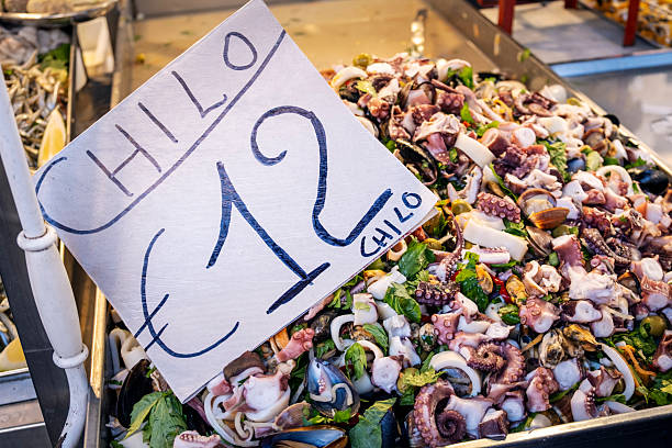 A market stall at Ballaro market in Palermo selling cooked octopus by the kilogram.