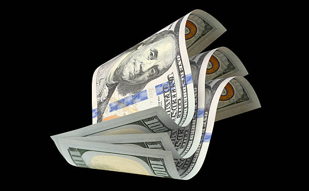 istock Flying hundred dollar banknotes, isolated on black background 2254326801