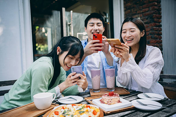 istock A group of young Asians is having a blast outdoors, laughing, chatting, and enjoying various activities together. 2254328109