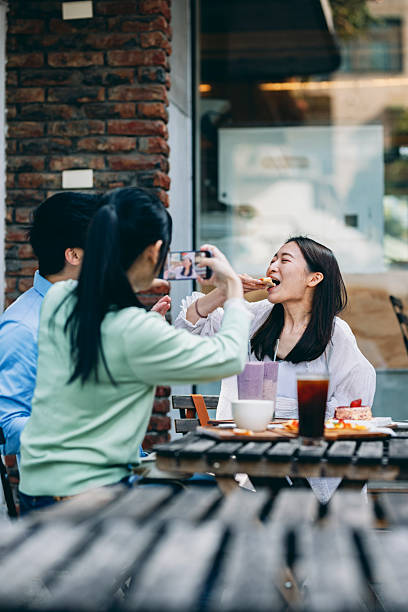 istock A group of young Asians is having a blast outdoors, laughing, chatting, and enjoying various activities together. 2254328147