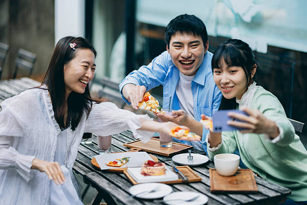 istock A group of young Asians is having a blast outdoors, laughing, chatting, and enjoying various activities together. 2254328215