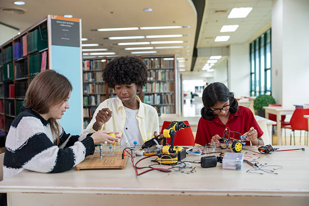 istock Group of students collaborating on electronics and robotics project in library school 2254333617