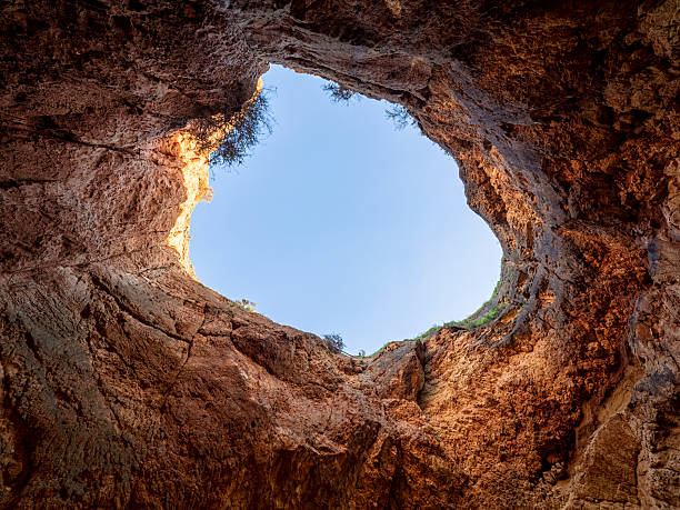 Portimão, Portugal. Looking up through a large natural rock skylight opening above the famous Benagil Cave