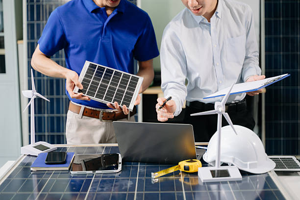 istock Two Asian engineers collaborate on a solar and wind energy project, discussing innovation and sustainability 2254335944