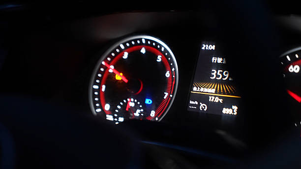 Vilnius, Lithuania - April 11, 2023: Original speed and rev gauges in the dashboard of a vintage Datsun 240Z. Dash freshly reupholstered in black leather. Seen through original leather steering wheel.