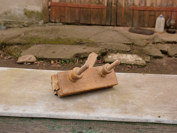 Wooden hand plane on windowsill. Old carpenter tool for shaping and smoothing wood.