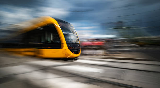 Rushing Yellow Tram With A Motion Blur Effect Moves By A City Street In Budapest