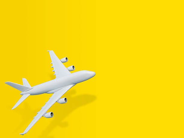 Miniature airplane on yellow background.