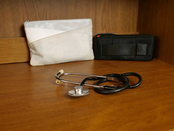 istock Stethoscope lying on wooden surface, medical diagnostic instrument in home interior. 2254342676
