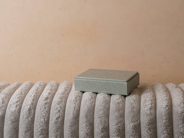Small gift box placed on soft blanket, minimalist item for storage or present.