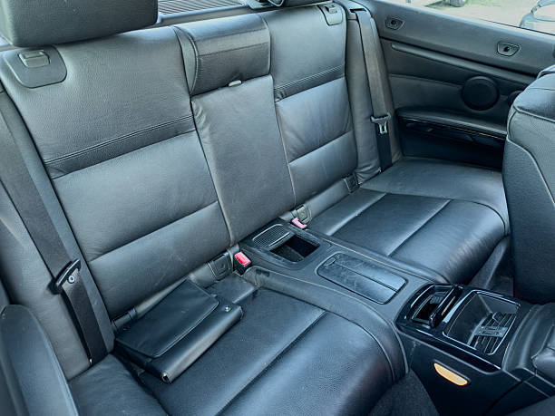 istock Comfortable black leather car interior with spacious back seat suitable for passengers and storage 2254343927