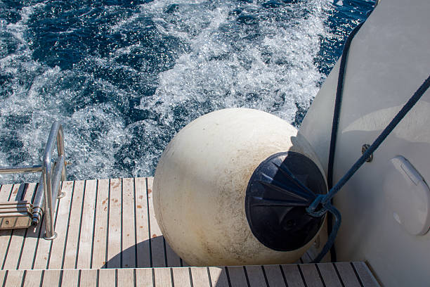 This image features a ball fender on a catamaran, showcasing an essential accessory for protecting the vessel during docking and mooring. The fender, with its bright color and round shape, not only serves a practical purpose but also adds a touch of nautical charm to the boat's aesthetic. Set against the backdrop of tranquil waters, this visual captures the essence of boating life and the importance of safety at sea. Ideal for maritime-themed projects, sailing promotions, or lifestyle content, this image evokes a sense of adventure and relaxation, making it a perfect choice for those looking to illustrate the enjoyment and functionality of catamaran sailing.