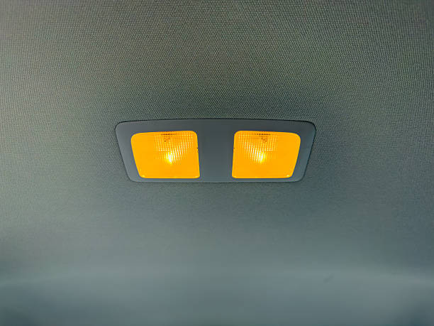 istock Interior overhead lights in a car cabin shining brightly during a night drive on a smooth road 2254347423