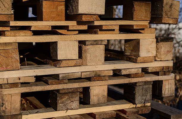 istock Stacked wooden pallets in warm evening sunlight. 2254347551