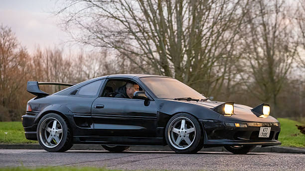 Milton Keynes,Bucks,UK - Jan 1st 2026:  1994 Toyota MR2 classic car with pop up headlights driving on a British road