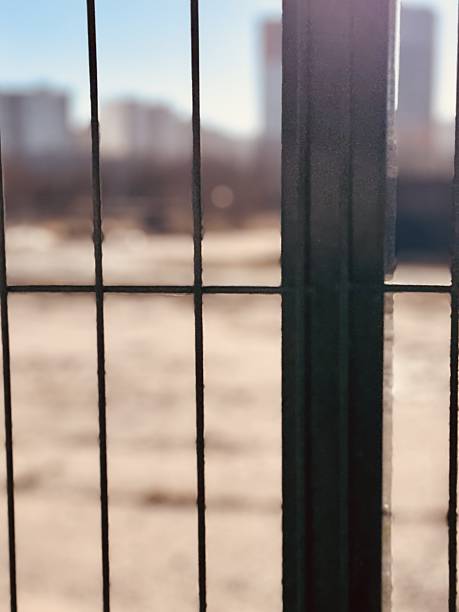 istock Industrial Fence Design, Contrasting Vibrant Colors Emphasize Security And Simplicity, Striking Geometric Pattern Of Metal Fence Highlights Boundaries Against Vivid Sky Background 2254352508