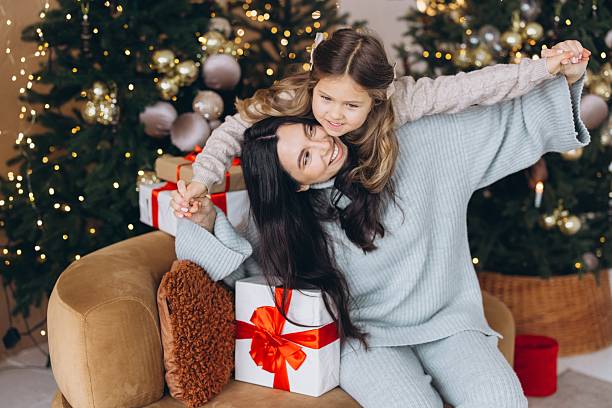 istock Mother and daughter having fun celebrating Christmas together 2254354451