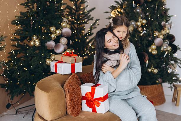 istock Mother and daughter embracing during Christmas celebration at home 2254354455
