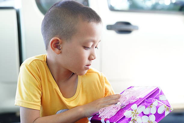 Little boy lying on the couch reading a book