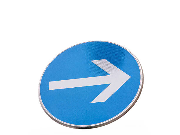 istock Blue circular road sign with white arrow on white background 2254356275