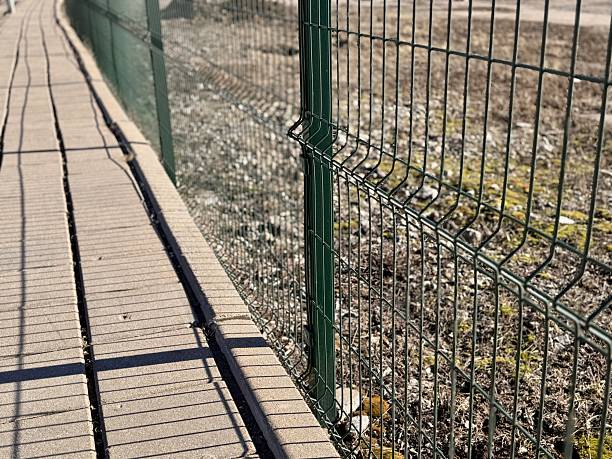 istock Fence With Blurred Background, Detailed View Of Wire Mesh With Peaceful Outdoor Setting, An Intimate Shot Of Fence Mesh Illuminated By Gentle Sunlight Amidst Tranquil Surroundings 2254357270