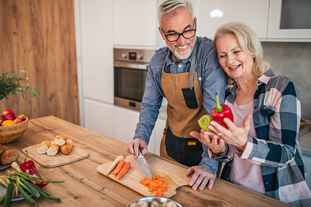 istock Smiling senior married couple preparing lunch together in the kitchen 2254358402