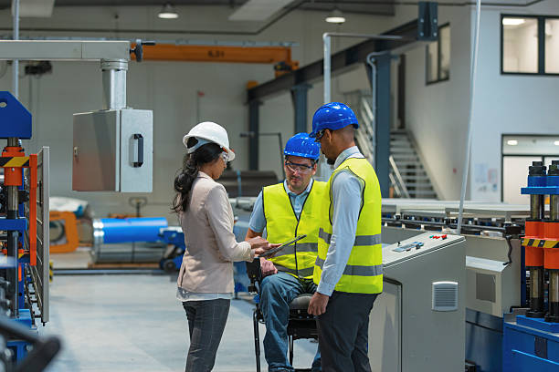 istock CEO touring factory with an employee, worker with a disability completing tasks 2254359432