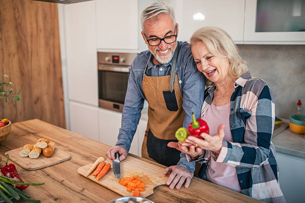 istock Mature married couple preparing lunch together in the kitchen 2254359697