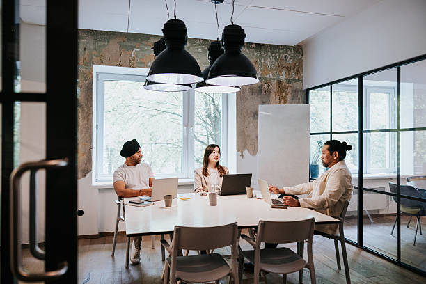istock Multi-ethnic coworkers collaborating in a modern open-plan office space 2254360018