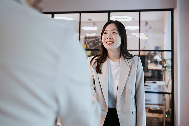istock Business professionals greeting with confidence in a modern open-plan office setting 2254360080
