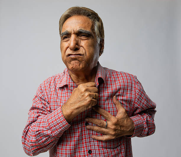 istock Old man suffering from heart attack on white background 2254360372