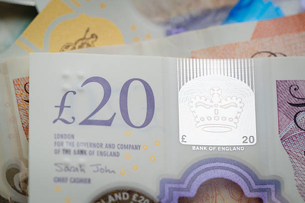 istock A close-up view of a British £20 note showing holographic and embossed security features including a comb pattern and royal emblem. The reflective materials and intricate elements highlight modern banknote technology. 2254363803