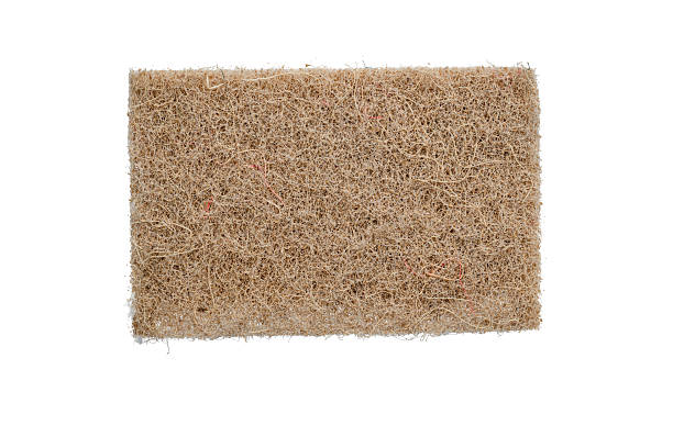 istock A rectangular brown coconut fiber mat is centered on a white background, showing a coarse and tangled surface texture. The natural look and isolated presentation highlight its organic and eco-friendly material. 2254363867