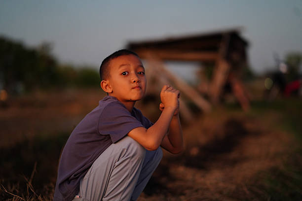 Two children playing in the nature outdoor in dusky day.