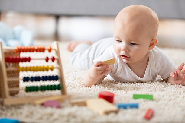 istock Baby playing with educational toys on a soft rug, learning colors and counting 2254367981