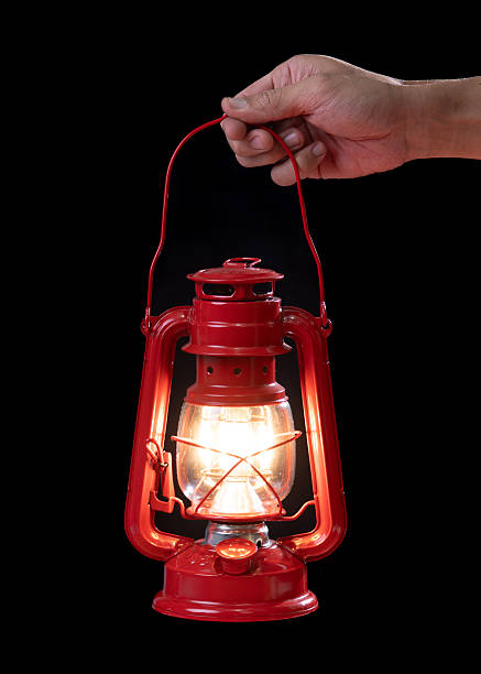 Hand holding an antique red lantern in the dark: Symbol of hope