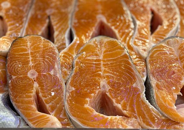 Brightly Colored Salmon Portions Shown, Highquality Pink Salmon Fillets On Display, Premium Quality Salmon Cuts With Striking Color And Appealing Presentation For Consumers