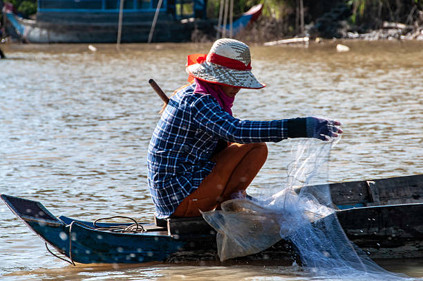 Chong Khneas, Tonle Sap Lake, Cambodia - oct 30, 2015 : Cambodian fisherman cast  nets in the canals around the great Tonle Sap Lake.
