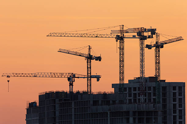 istock Industrial cranes at sunset on a construction site 2254373571