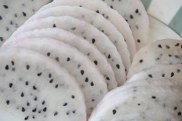 Freshly cut dragon fruit slices arranged neatly on a plate.