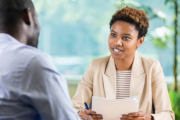 istock Business meeting with documents and focused discussion between two colleagues in an office setting. 2254376058