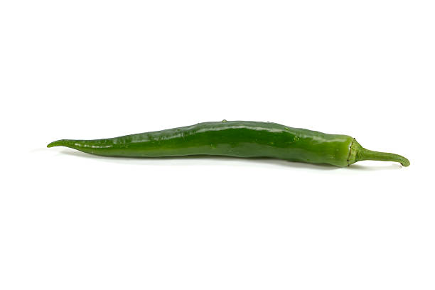 Single green chili pepper isolated on white background. Fresh spicy vegetable representing cooking, seasoning, and healthy food concepts.