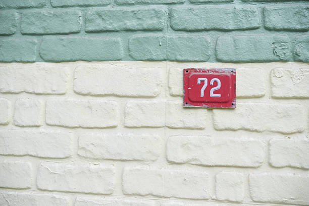 istock House number 72 on a colorful textured wall 2254379996