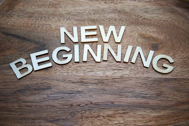 istock New beginning concept with wooden letters on wood material background copy space 2254381521