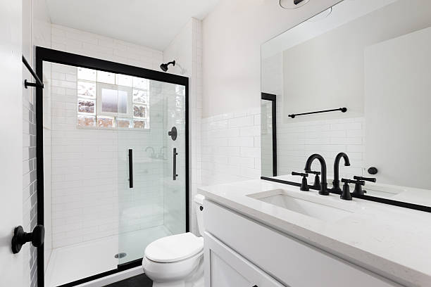 istock A white bathroom with black fixtures and subway tile shower. 2254385239